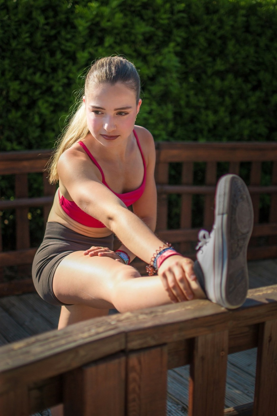 Young athlete stretching outdoors in natural light